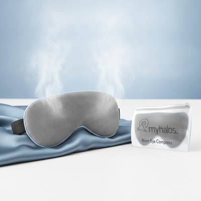 A studio shot of a microwave-activated warm eye compress, showing its soft texture and contoured shape, with subtle steam. Th